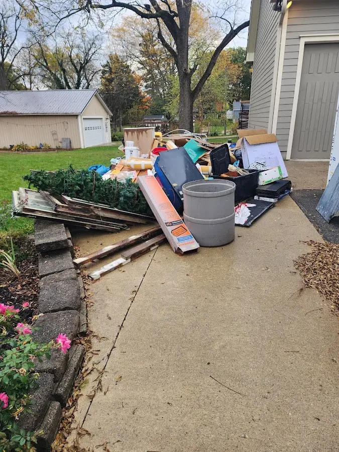 Dumpster being loaded with debris for 10 Yard Dumpster Rental in Lake Tapps